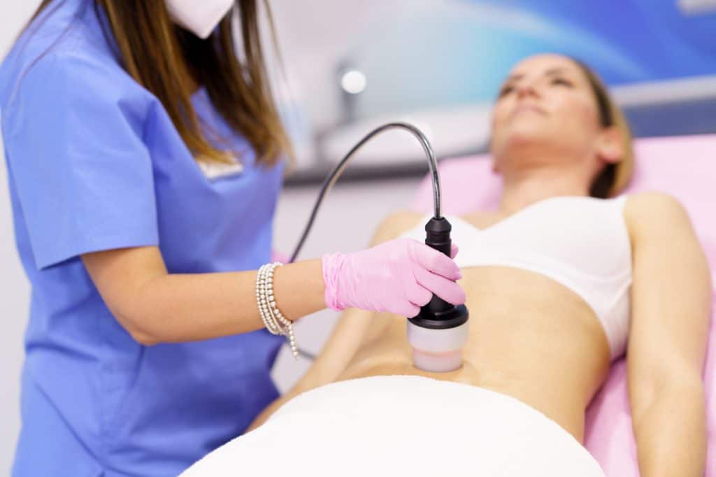 woman receiving anti cellulite treatment with radiofrequency machine in a beauty center